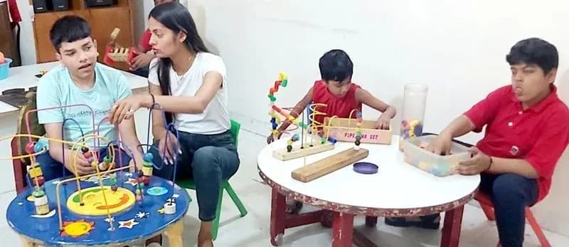 Occupational therapist working with children at a table