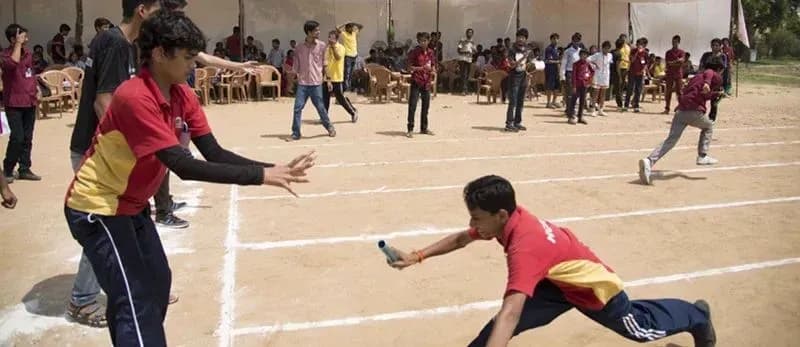 Children taking part in a sports day relay race